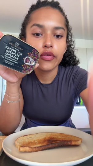 TikTok post by @elise388: The creator demonstrates how to assemble a mackerel-topped sourdough toast for lunch.…